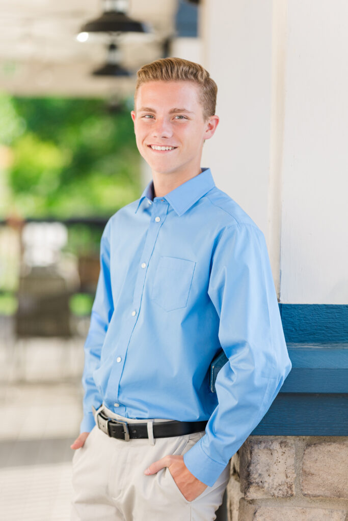 All-American style senior photo of a teen boy in a crisp blue shirt, golden hour summer portrait by Heather Lilly Photography in Northern Colorado