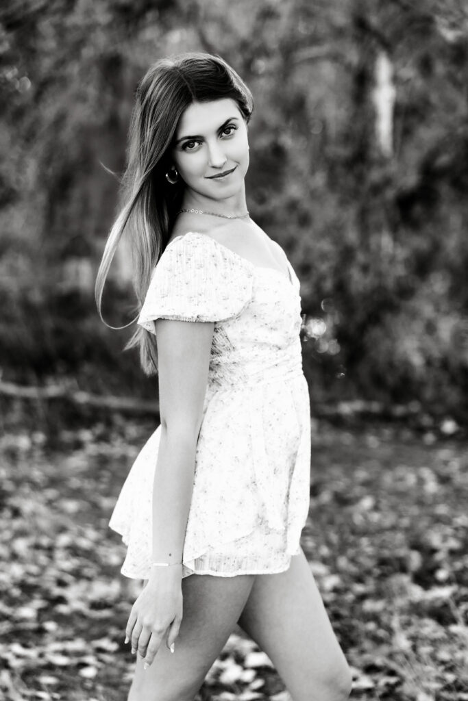 Black and white senior portrait in Greeley CO with soft expression and direct gaze, timeless and polished outdoor session.