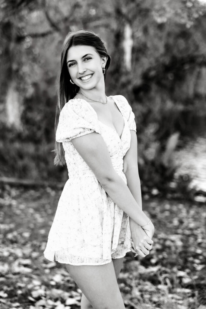 Black and white senior portrait in Greeley CO showing movement and emotion in a dance-inspired pose.