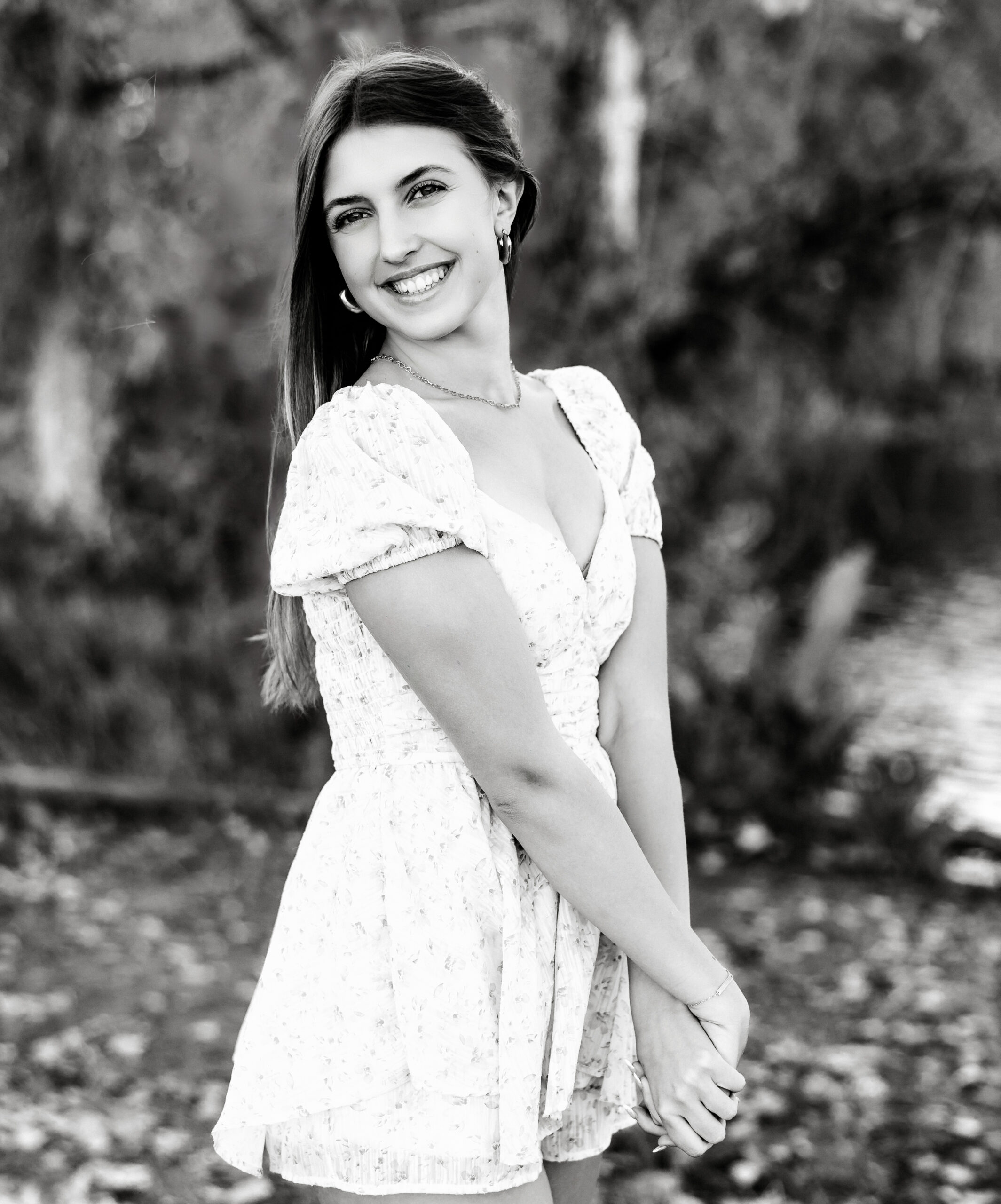 Black and white senior portrait in Greeley CO with soft expression and natural light, timeless editorial style