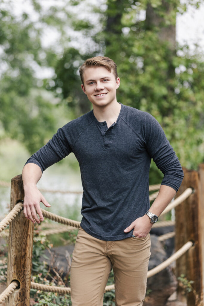 Senior portrait of a teen guy with perfect bokeh background at Waneka Lake in Lafayette, Colorado, captured by Northern Colorado senior photographer Heather Lilly