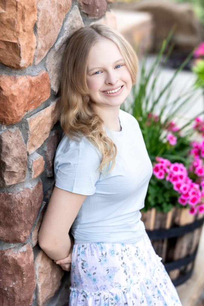 Blonde teen girl smiling in soft blue top during back-to-school micro-session, Greeley CO