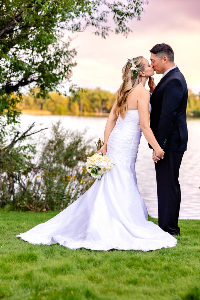 Husband and wife sharing a kiss during their 15-year anniversary portraits at Lions Park in Cheyenne, Wyoming, photographed by Heather Lilly Photography.