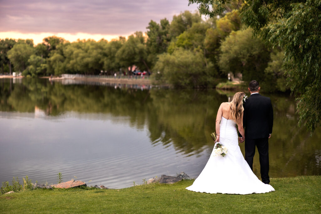 Wife leaning on Husband during their 15-year anniversary portraits at Lions Park in Cheyenne, Wyoming — a recreation of their 2010 wedding photo, captured by Heather Lilly Photography.