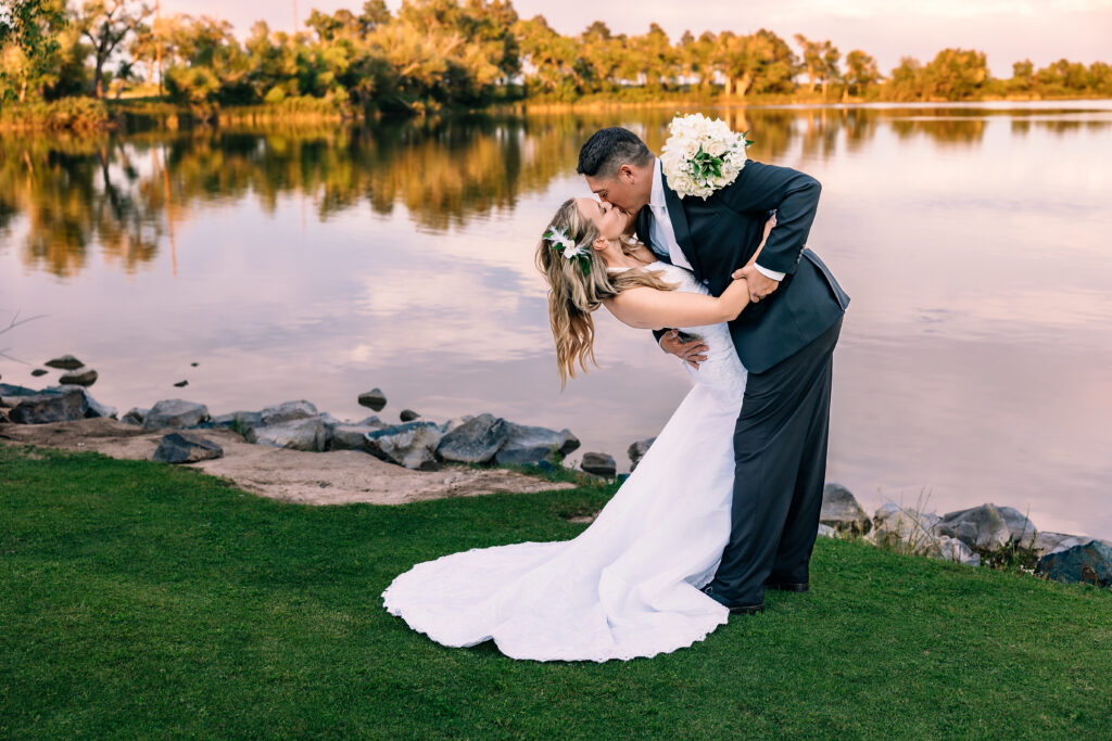 Husband and wife dip-kissing during their 15-year anniversary portraits at Lions Park in Cheyenne, Wyoming — a recreation of their 2010 wedding photo, captured by Heather Lilly Photography.