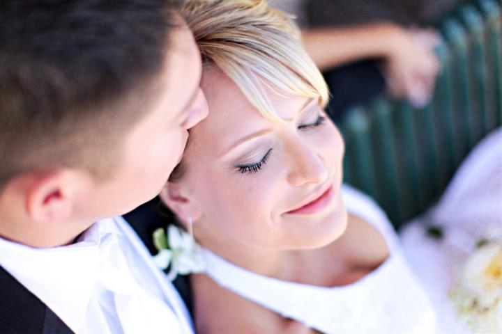 Husband and wife snuggling during their wedding portraits at Lions Park in Cheyenne, Wyoming, captured by Heather Lilly Photography in 2010.