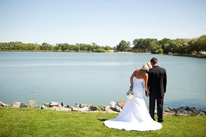 Wife leaning on Husband during their wedding portraits at Lions Park in Cheyenne, Wyoming, captured by Heather Lilly Photography in 2010.