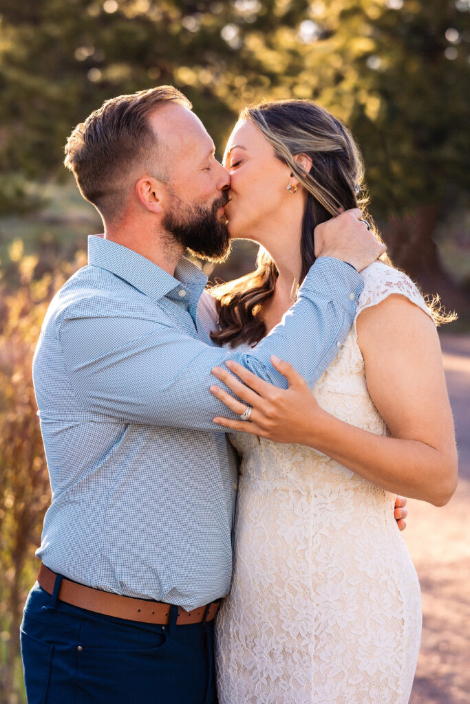 Husband and wife kissing during vow renewal at Lily Lake in Estes Park Colorado, photographed by Northern Colorado photographer Heather Lilly at golden hour in the mountains.