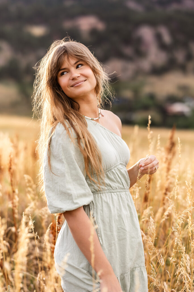 Golden hour portrait of Eden Alley in sage green dress, Flatirons backdrop, by Heather Lilly Photography.