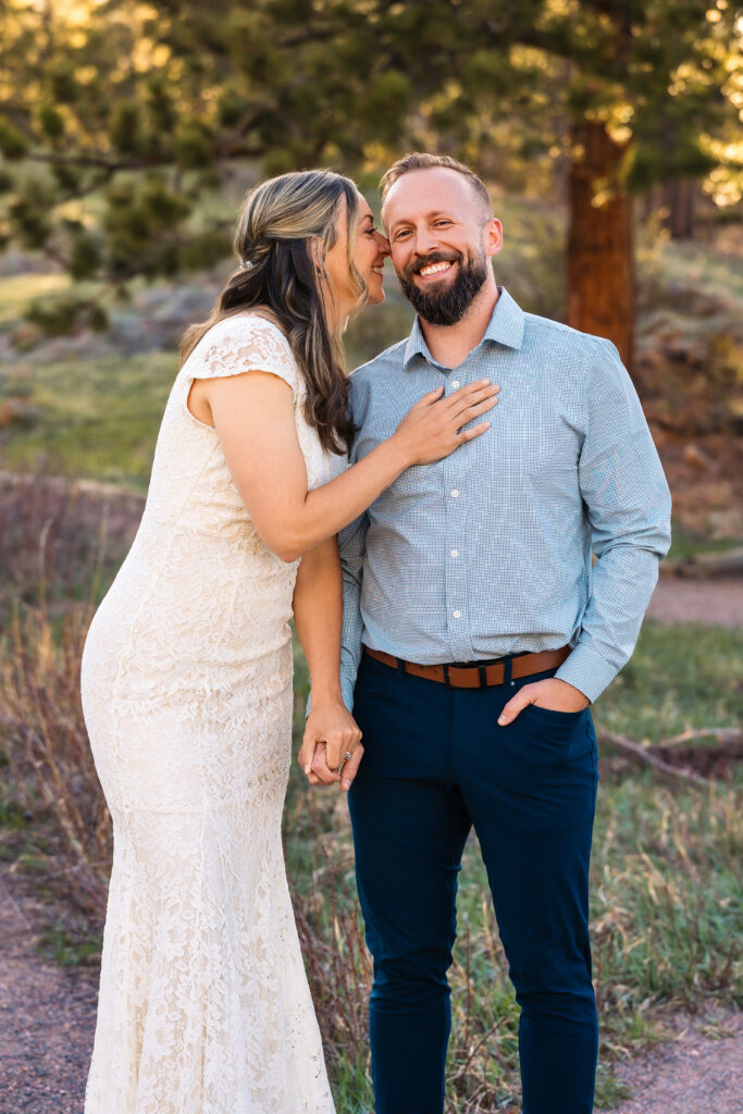Husband and wife smiling during vow renewal at Lily Lake in Estes Park Colorado, photographed by Northern Colorado photographer Heather Lilly at golden hour in the mountains.