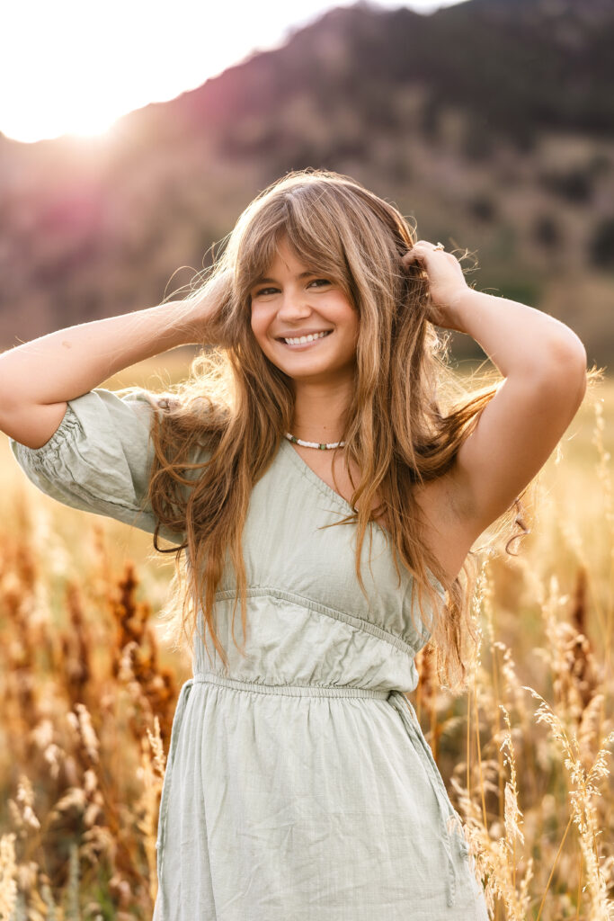 Eden Alley laughing in the meadow at Chautauqua Park during golden hour, editorial portrait by Heather Lilly Photography.