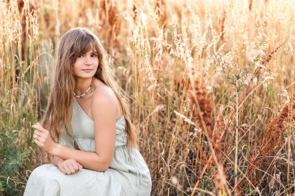 Warm autumn-toned portrait of Eden Alley, smiling softly, Chautauqua Park, Boulder.