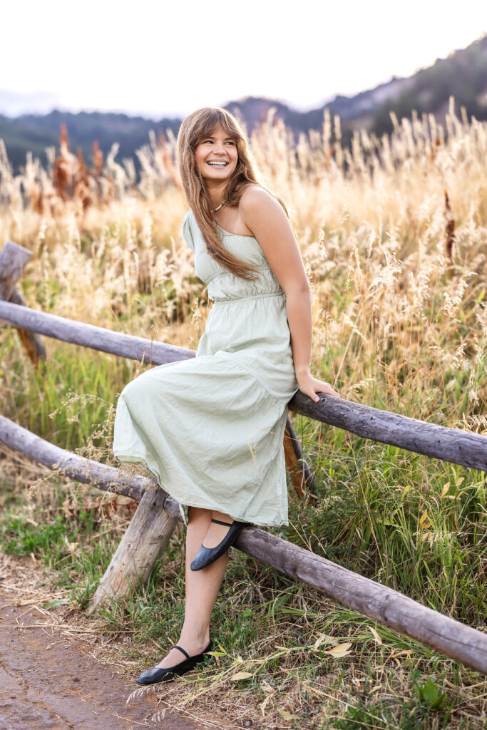 Joyful portrait of Eden Alley mid-laughter, glowing golden light, Chautauqua Park, Boulder.