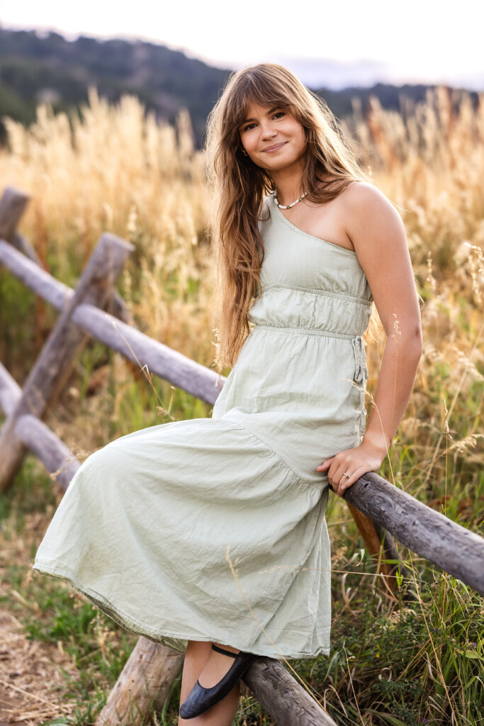 Film look portrait of Eden Alley in meadow grasses, warm color tones by Heather Lilly Photography.