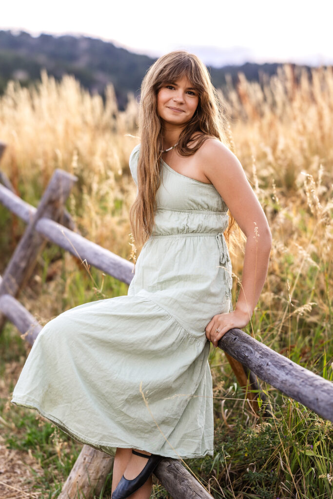 Film look portrait of Eden Alley in meadow grasses, warm color tones by Heather Lilly Photography.