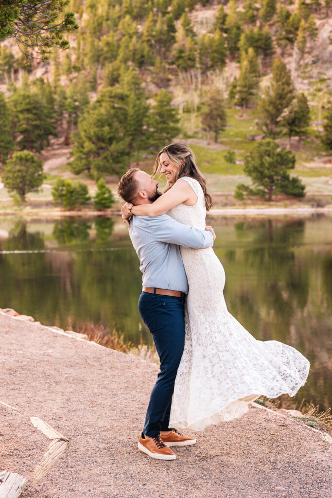 Husband and wife spinning during vow renewal at Lily Lake in Estes Park Colorado, photographed by Northern Colorado photographer Heather Lilly at golden hour in the mountains.