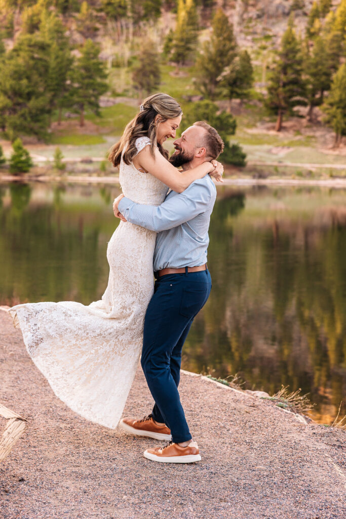 Husband and wife spinning during vow renewal at Lily Lake in Estes Park Colorado, photographed by Northern Colorado photographer Heather Lilly at golden hour in the mountains.