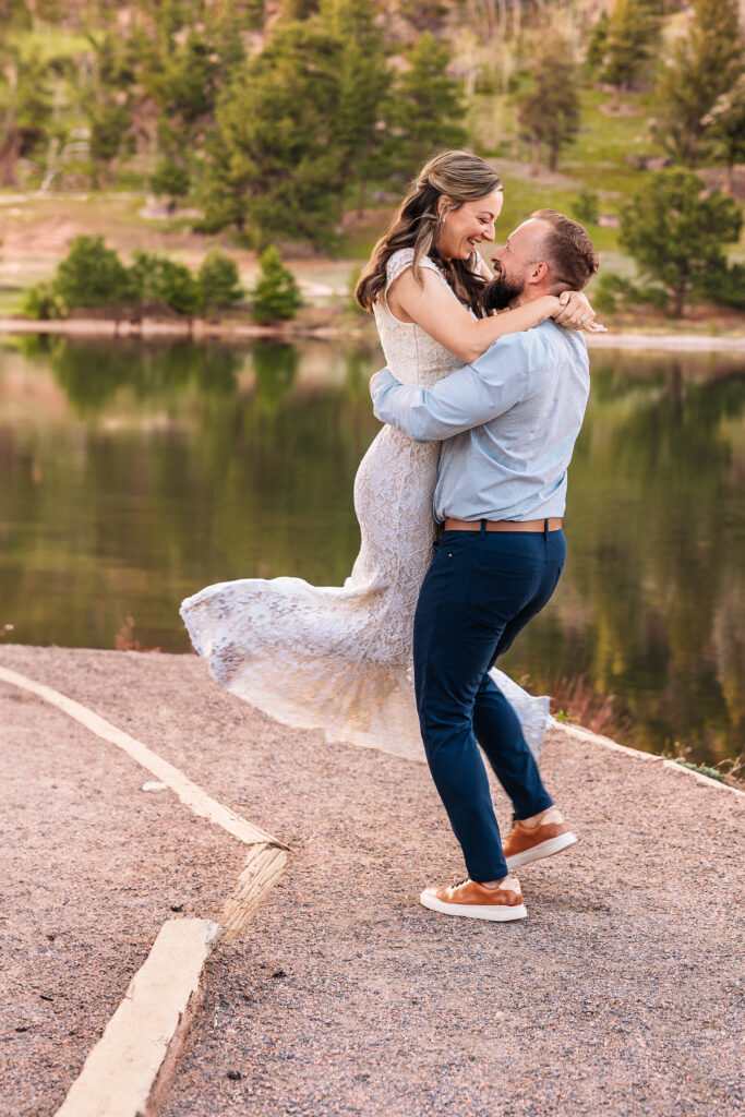 Husband and wife spinning during vow renewal at Lily Lake in Estes Park Colorado, photographed by Northern Colorado photographer Heather Lilly at golden hour in the mountains.