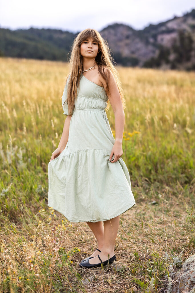 Sage green dress flowing in golden grass, film-inspired editorial portrait of Eden Alley by Heather Lilly Photography.