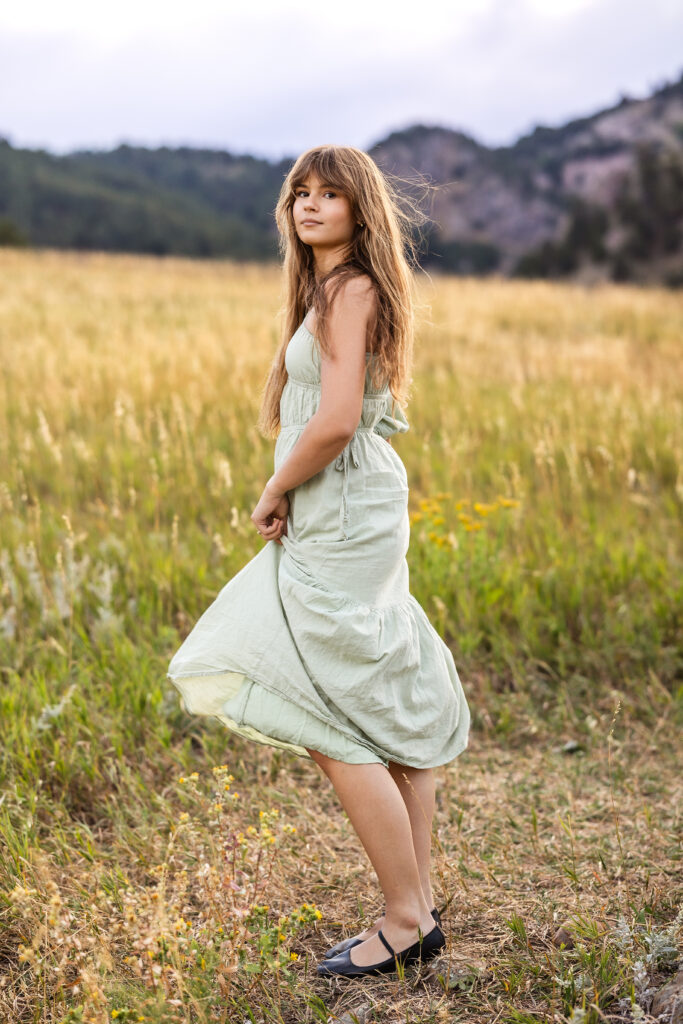 Sage green dress flowing in golden grass, film-inspired editorial portrait of Eden Alley by Heather Lilly Photography.