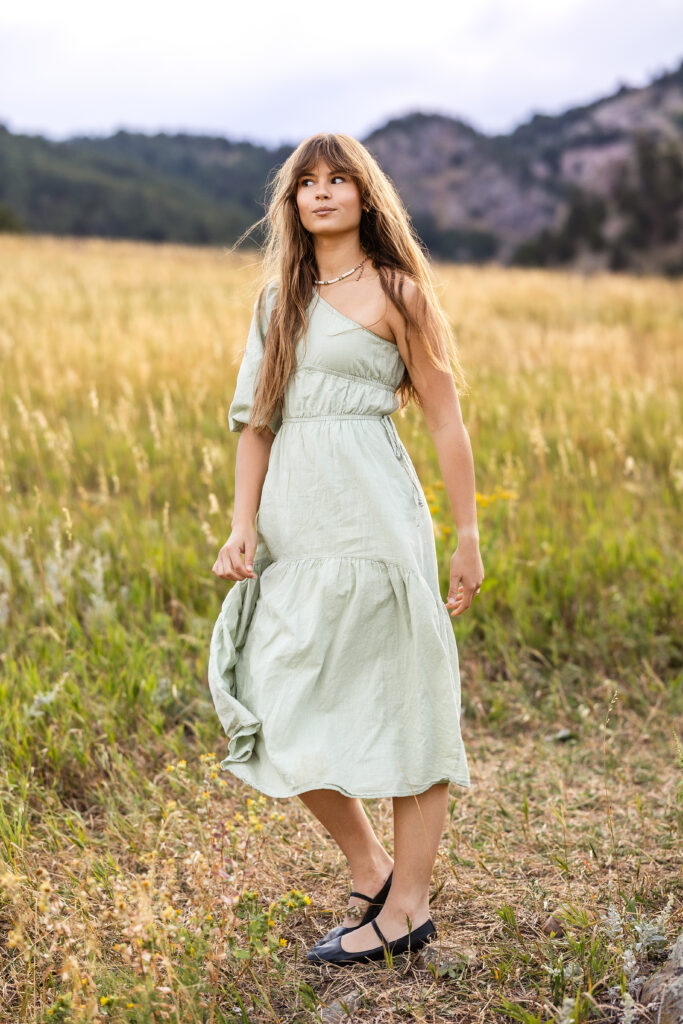 Sage green dress flowing in golden grass, film-inspired editorial portrait of Eden Alley by Heather Lilly Photography.