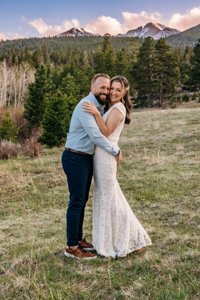 Husband and wife smiling during vow renewal at Lily Lake in Estes Park Colorado, photographed by Northern Colorado photographer Heather Lilly at golden hour in the mountains.