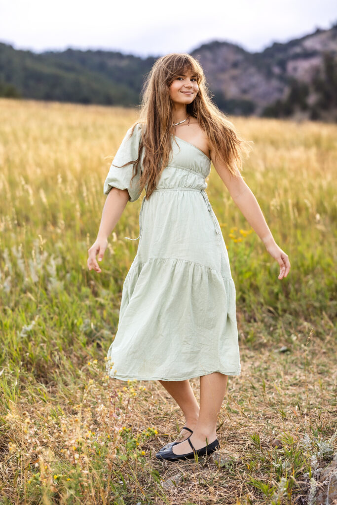 Sage green dress flowing in golden grass, film-inspired editorial portrait of Eden Alley by Heather Lilly Photography.