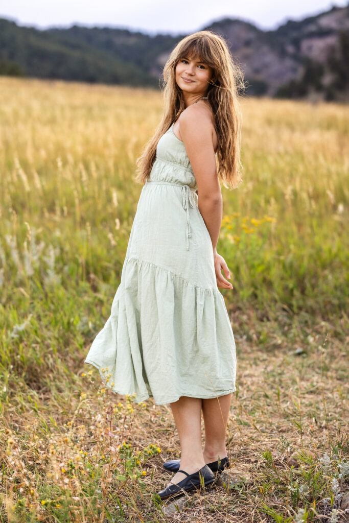 Sage green dress flowing in golden grass, film-inspired editorial portrait of Eden Alley by Heather Lilly Photography.