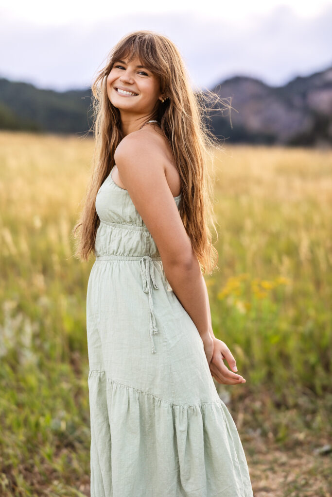 Sage green dress flowing in golden grass, film-inspired editorial portrait of Eden Alley by Heather Lilly Photography.