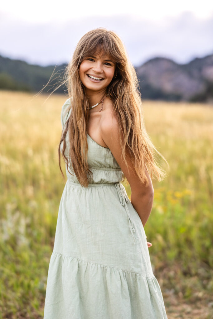 Sage green dress flowing in golden grass, film-inspired editorial portrait of Eden Alley by Heather Lilly Photography.