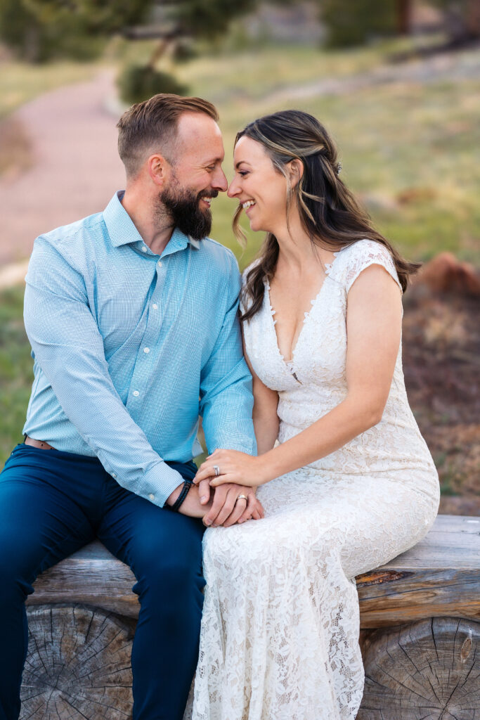 Husband and wife sitting during vow renewal at Lily Lake in Estes Park Colorado, photographed by Northern Colorado photographer Heather Lilly at golden hour in the mountains.